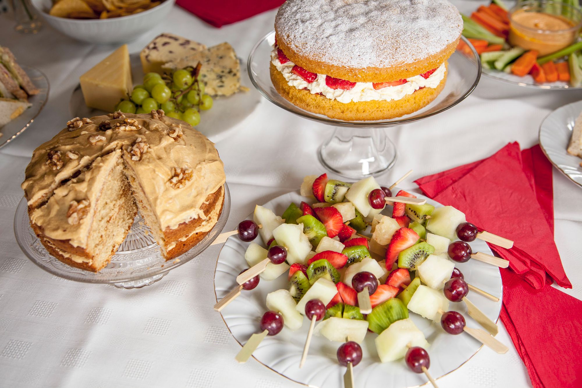 Fruit kebabs and cake display
